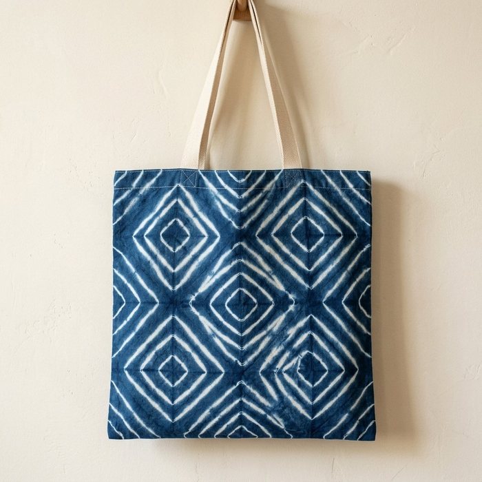Indigo tote bag patterned with a lattice of nested white diamonds