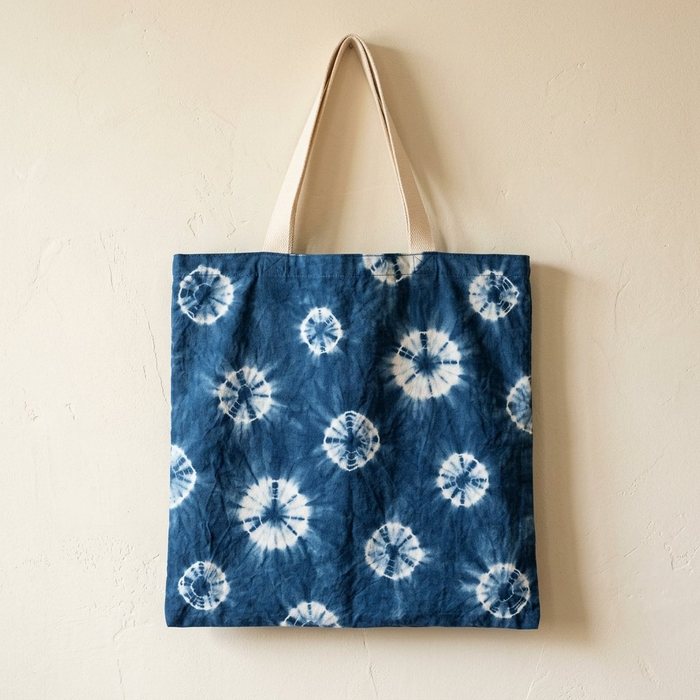 Indigo tote bag scattered with white starburst rosettes